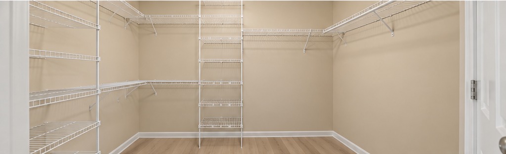 5 Richardson walk-in closet with beige walls and light wood LVP flooring